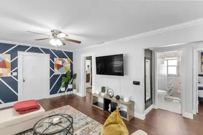 a living room with a couch and a tv at King bd Charming 2-Storey Cottage w PrivateYard in Orlando