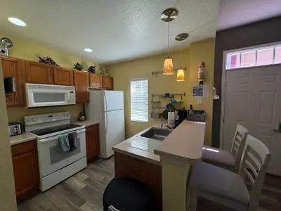 a kitchen with a sink and a stove top oven at 4 Bedroom 3 Bathroom Villas At SevenDwarfs 17-101 in Kissimmee
