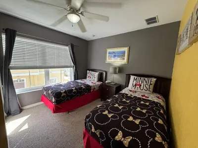 a bedroom with two beds and a ceiling fan at 4 Bedroom 3 Bathroom Villas At SevenDwarfs 17-101 in Kissimmee
