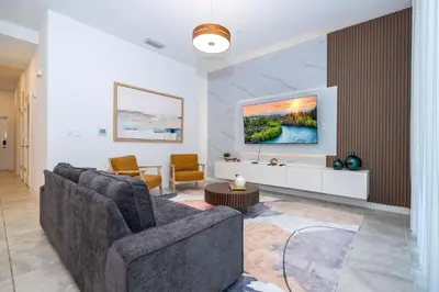 a living room with a couch and a tv at 3191#402 Family Fun 3BR Themed Apt Near Disney in Kissimmee