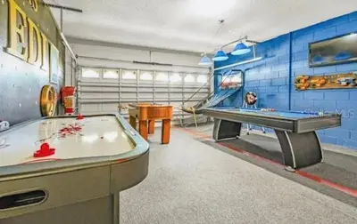a gaming room with a pool table and a ping pong table at Enchanted Disney Vacation Villa in Kissimmee