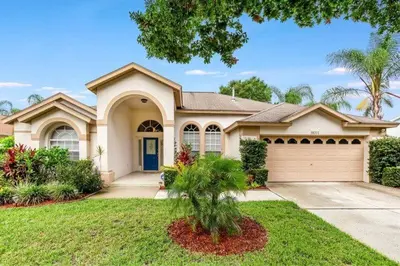 a large house with a garage at Beautiful 4 Bed Villa With Southwest Facing Pool in Orlando