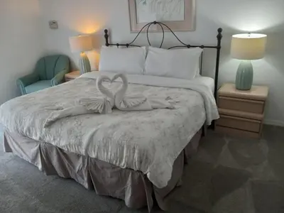 a bedroom with a bed with a towel on it at Fabulous 4 Bed South Facing Lake View Near Disney in Orlando