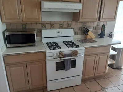 a kitchen with a white stove and a microwave at Fabulous 4 Bed South Facing Lake View Near Disney in Orlando