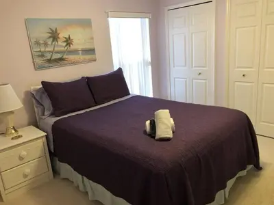 a bedroom with a bed with a towel on it at Spacious 4 Bed South Facing Pool Villa Near Disney in Orlando