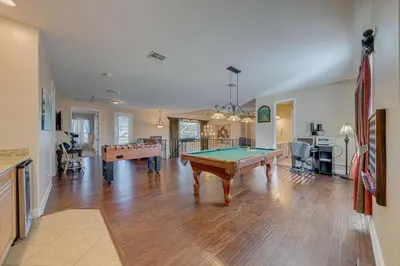 a living room with a pool table in it at Spacious 7 Bedroom Home Close To Disney in Orlando