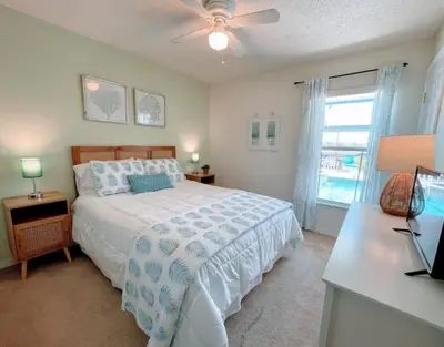 a bedroom with a bed and a ceiling fan at Hidden Waterfront Oasis - 18 Minutes To The Disney in Orlando
