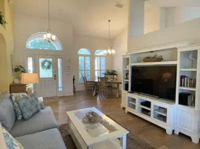 a living room with a couch and a tv at Hidden Waterfront Oasis - 18 Minutes To The Disney in Orlando