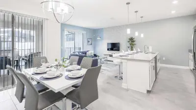 a dining room and living room with a table and chairs at Perfect Storey Lake Home for Great Vacation in Kissimmee