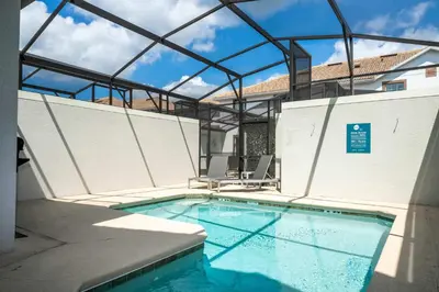 a large swimming pool with a glass roof at Storey Lake Home Mickey & Minions Beds Sleeps 12 in Kissimmee