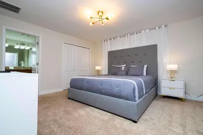 a bedroom with a large bed and a mirror at Great Home Mickey & Harry Potter Beds Top Spot in Kissimmee