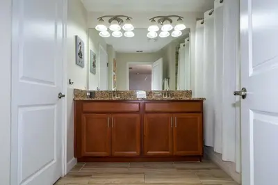 a bathroom with a sink and a large mirror at Great Home Mickey & Harry Potter Beds Top Spot in Kissimmee