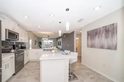 a kitchen with white cabinets and a white counter top at Elegant 2Bed Condo in Storey Lake Prime Location in Kissimmee
