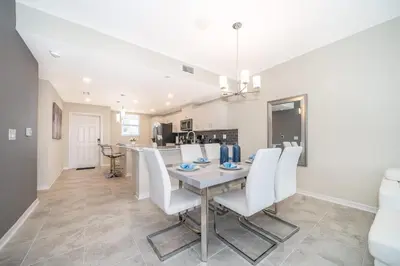 a dining room and kitchen with a table and chairs at Elegant 2Bed Condo in Storey Lake Prime Location in Kissimmee