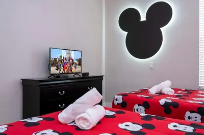 two beds with hello kitty pillows in a bedroom at Modern Chic Home Mickey and Toy Story Rooms in Orlando