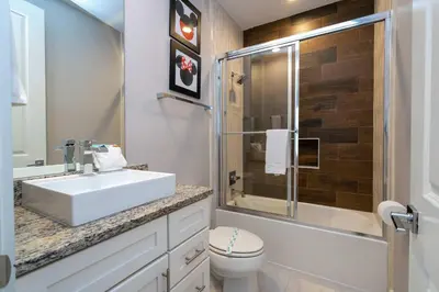 a bathroom with a sink and a toilet and a shower at Modern Chic Home Mickey and Toy Story Rooms in Orlando