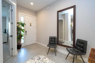 two black chairs in a room with a mirror at Modern Chic Home Mickey and Toy Story Rooms in Orlando