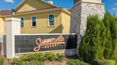a yellow house with a sign for a summerville resort at Chic 4 Bedroom at Summerville Minutes from Disney in Orlando