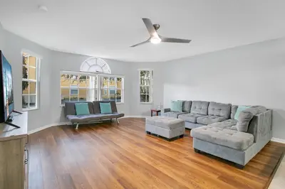 a living room with two couches and a tv at Familiar Retreat with Resort Access Near Disney in Kissimmee
