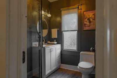 a bathroom with a toilet and a sink and a window at Historic orlando Casita Joy, DT, Lake Eola, Delaney park, 2 bedrooms 1 bathroom Unit B in Orlando