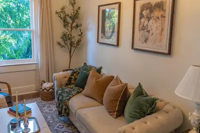 a living room with a couch and a table at Historic orlando Casita Joy, DT, Lake Eola, Delaney park, 2 bedrooms 1 bathroom Unit B in Orlando