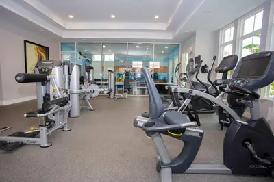 a gym with several treadmills and cardio machines at Stylish 4Bed Townhome at Summerville Near Disney in Orlando