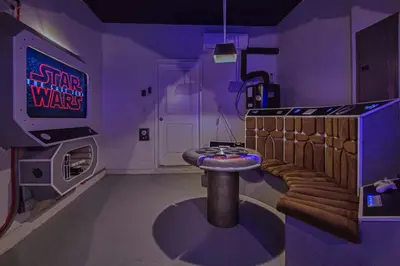 a room with a star wars room with a stool at Chic Home Themed Bedrooms Game Room Best Spot in Kissimmee