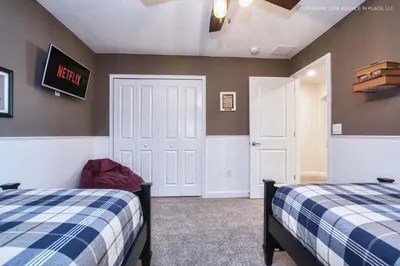a bedroom with two beds and a exit sign on the wall at Chic Home Themed Bedrooms Game Room Best Spot in Kissimmee