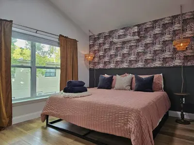 a bedroom with a bed with a large window at The Catherine - 1 mile to downtown - 2 King beds - Sleeps 5 in Orlando
