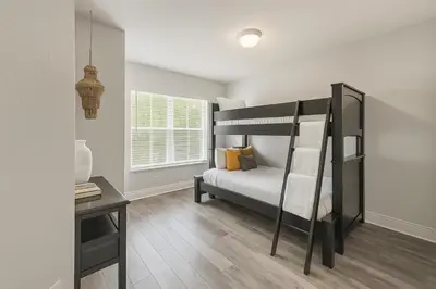 a bedroom with a bunk bed and a desk at Disney-Area 3BR Townhome | Sleeps 9 | Pool + Gym in Kissimmee