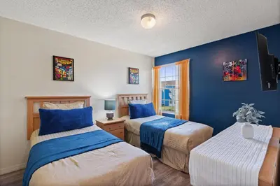 a bedroom with two beds with blue walls at 2721 North Poinciana #164 in Kissimmee