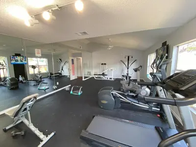 a room with a gym with a treadmill and exercise equipment at 2721 North Poinciana #164 in Kissimmee