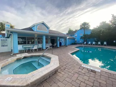 a house with a swimming pool in front of a house at 2721 North Poinciana #164 in Kissimmee