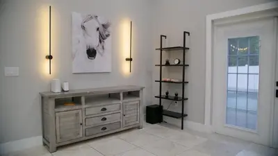 a room with a dresser with a picture of a horse on the wall at Luxury home with Pool & 6 Beds near Disney in Kissimmee