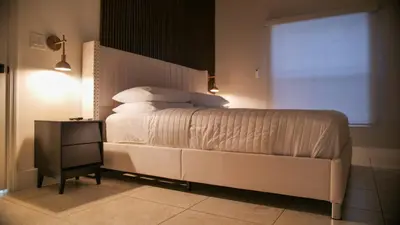 a bedroom with a large bed and a window at Luxury home with Pool & 6 Beds near Disney in Kissimmee