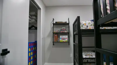 a childs bedroom with a bunk bed and a ladder at Luxury home with Pool & 6 Beds near Disney in Kissimmee