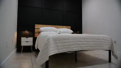 a bedroom with a bed with a black headboard at Luxury home with Pool & 6 Beds near Disney in Kissimmee