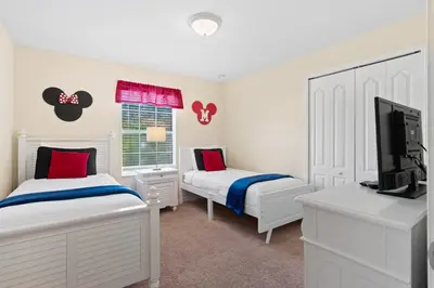 a bedroom with two beds and a flat screen tv at 5 BD 4 BA Private Pool Paradise Palms (8839 CP) in Kissimmee