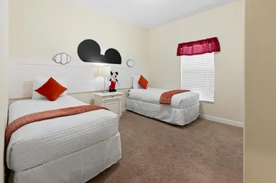a bedroom with two beds and a window at 5 BD 4 BA Private Pool Paradise Palms (8839 CP) in Kissimmee