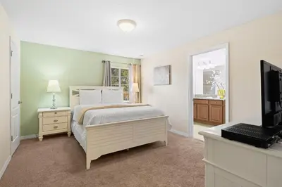 a bedroom with a bed and a television in it at 5 BD 4 BA Private Pool Paradise Palms (8839 CP) in Kissimmee