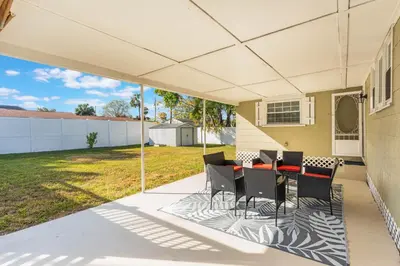 a patio with a table and chairs on it at Sanford's Haven, 3 Bedroom, Sleeps 7 in Sanford