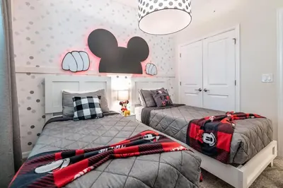 a bedroom with two beds and a wall with hearts at Chic 2Bed Condo at Storey Lake Mickey Room in Kissimmee