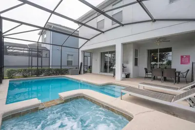 a swimming pool in a house with a building at Home 6Bed , Themed Rooms, Game Room, Storey Lake in Kissimmee