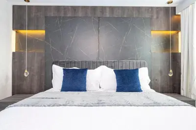 a bedroom with a large bed with blue pillows at The Ultimate 9bd Disney Getaway Storey Lake in Kissimmee