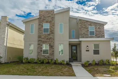 a large brick house with at The Ultimate 9bd Disney Getaway Storey Lake in Kissimmee