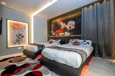 a bedroom with two beds and a rug at The Best Paradiso Vacation House in Orlando