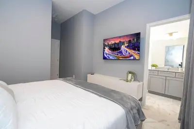 a bedroom with a white bed and a sink at The Best Paradiso Vacation House in Orlando