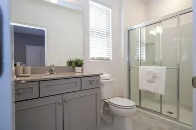 a bathroom with a toilet and a sink and a shower at The Best Paradiso Vacation House in Orlando