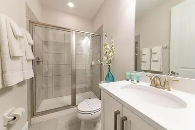 a bathroom with a shower and a sink and a toilet at Fantastic Disney Vacation W Pool and Movie Theater in Orlando