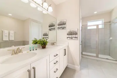a white bathroom with a sink and a shower at Fantastic Disney Vacation W Pool and Movie Theater in Orlando